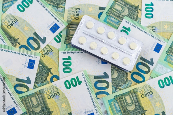 Obraz Top view on blisters with pills on euro bills as background. High cost of medical supplies concept