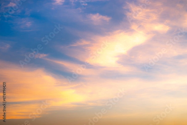 Fototapeta Real amazing Beautiful sunrise and luxury soft gradient orange gold clouds with sunlight on the blue sky perfect for the background, take in everning, Twilight sunset sky with gentle colorful clouds