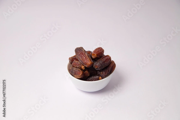 Fototapeta Dates in the white vessel with white background, variety of dates, dates in glass bowl, safawi or Pairom