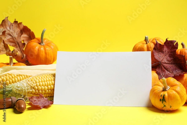 Obraz Thanksgiving day. Beautiful composition with pumpkins and blank card on yellow background, space for text