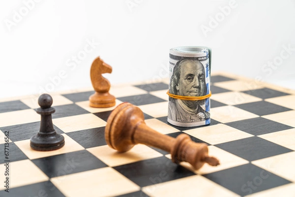 Obraz Chess game and rolled dollar bills as chess piece, black pawn and white knight, Benjamin Franklin bills, white king down. Concept of business strategy, dollar leadership