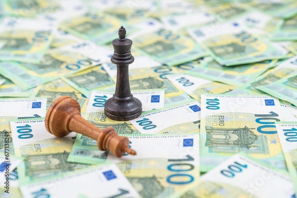 Obraz Chess pieces on multiple 100 euro bank notes. Black king up and white king defeated. Concept of stock market competition.