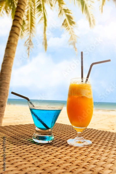 Fototapeta Two fresh cocktail on a beach under palm tree