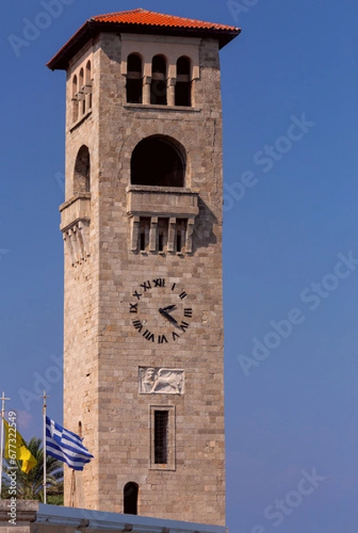 Fototapeta Tall Venetian tower in front of the old Orthodox Greek church in Rhodes.