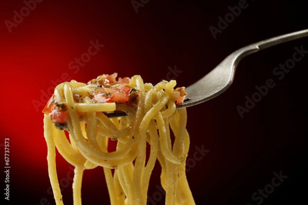 Fototapeta Italian pasta spaghetti on fork on dark background