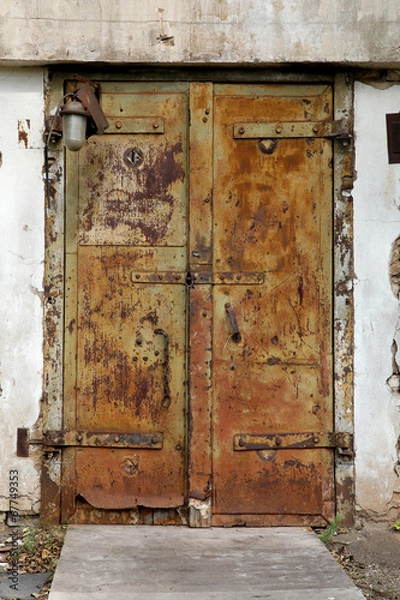 Obraz rusty old metal door in an abandoned factory
