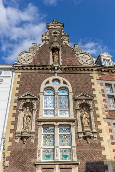Fototapeta Facade with statues on a historic house in Roermond, Netherlands