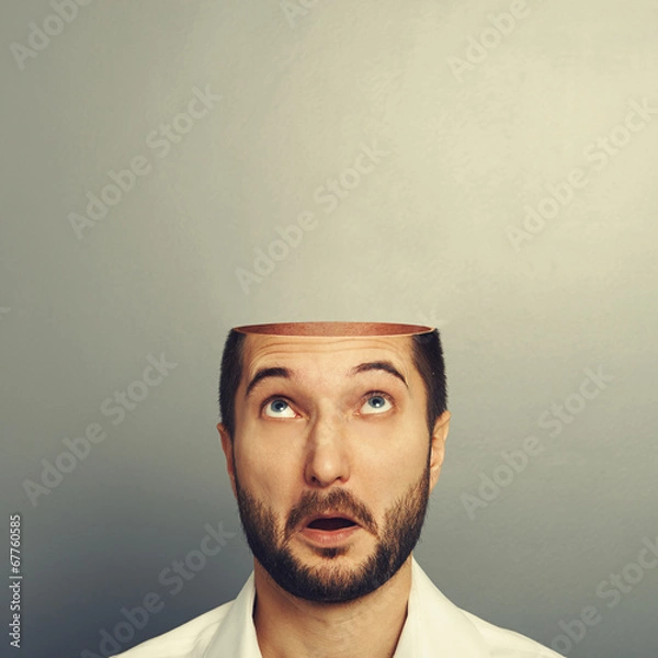 Fototapeta surprised man looking up at his open empty head