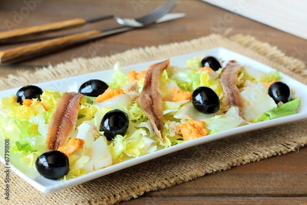 Fototapeta Cod, anchovies, and black olives salad