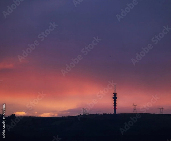 Fototapeta Sunset with mountain views and a radio tower