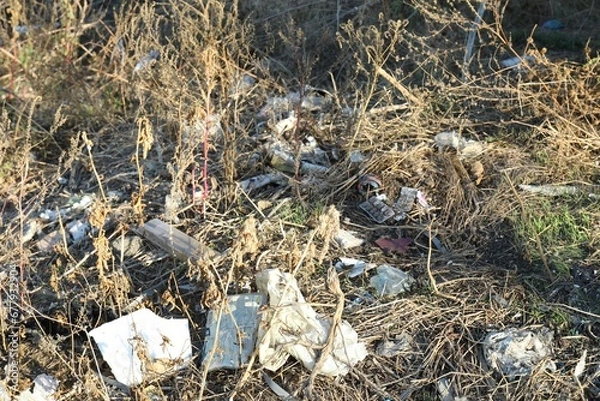 Fototapeta Different plastic garbage outdoors. Environmental pollution concept