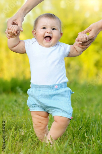 Fototapeta cute little baby doing first steps