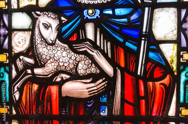Obraz Stained glass window in a church showing Jesus holding a lamb and depicted as a shepherd