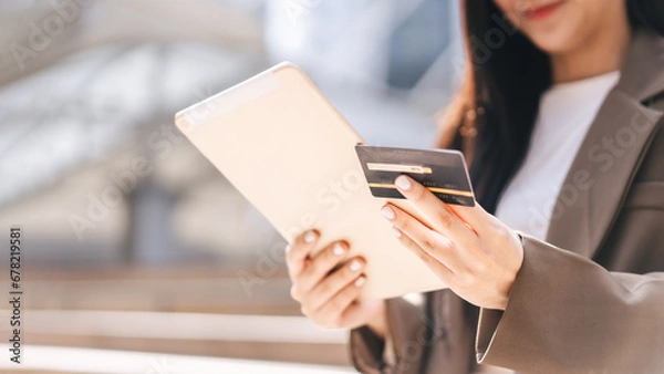 Obraz Happy smile young woman using creadit card and digital tablet for shopping online payment