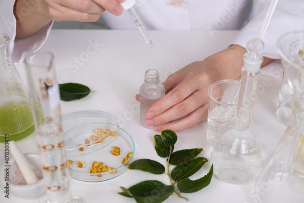 Fototapeta Dermatologist is dropping the skincare serum for dermatology tests in the laboratory . professtional cosmetic and skincare concept.