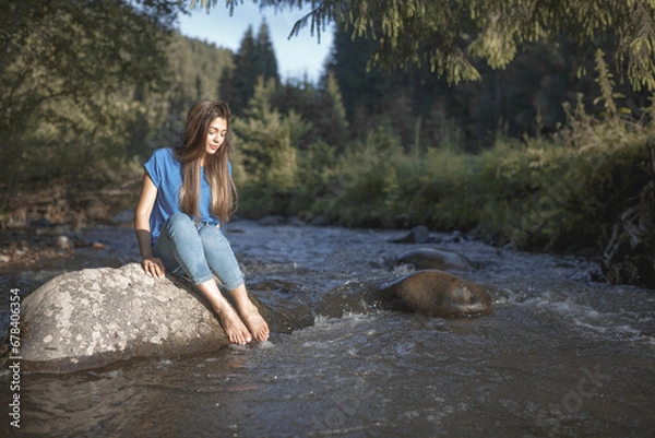 Fototapeta Lady on a rock in the river
