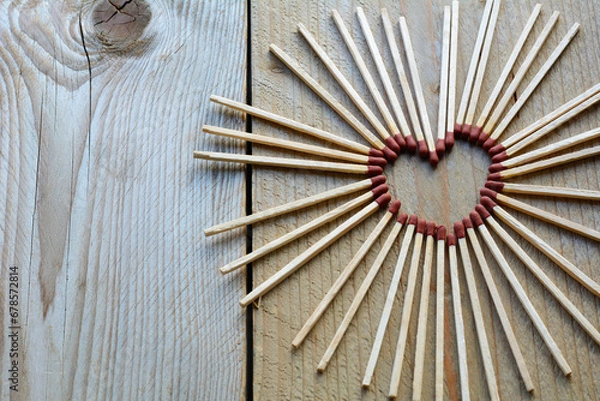 Obraz Childish heart from matches on the wooden background. Many long matches in heart form for men