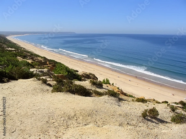 Fototapeta Fonte da Telha Beach in Costa da Caparica coast, with the Espichel Cape seen at the Atlantic Ocean horizon. Portugal