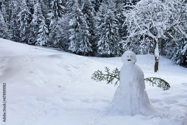 Fototapeta snowman in winter forest in Alps, sad weird snowman