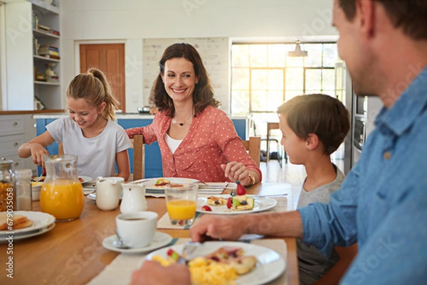 Fototapeta Smile, food and morning with a family in the dining room of their home together for health or nutrition. Mother, father and happy sibling kids eating breakfast at a table in an apartment for bonding