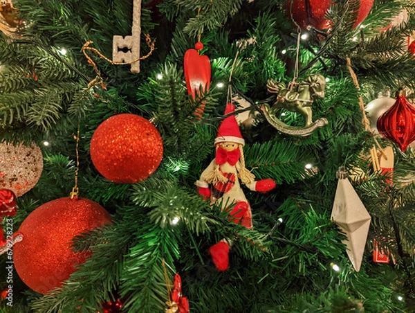 Obraz Red toy balloons are hanging on the Christmas tree. close-up