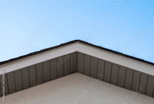 Obraz Top of house roof edge on clear sky.