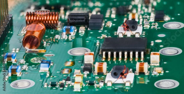 Fototapeta Closeup of surface mounted electronic components in radio-frequency circuits of TV tuner. Semiconductor microchip and air core coils with various small inductors, capacitors or resistors on green PCB.
