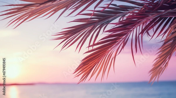 Fototapeta Palm leaves on tropical sunset beach background. Summer and travel concept. Generative ai.
