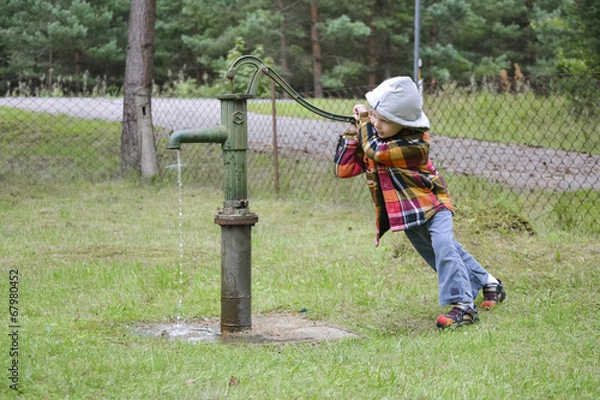 Fototapeta Boy and water pump