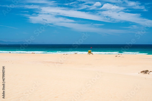 Fototapeta View of the beaches and dunes of Corralejo and a lifeguard hut. Photography taken in Spain, Canary Islands, Fuerteventura.