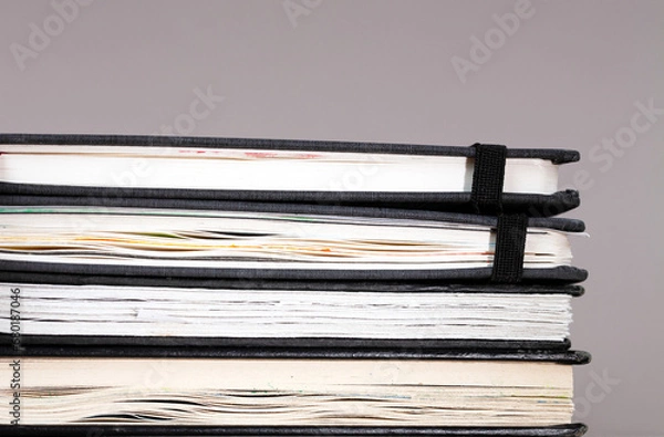 Fototapeta stack of used sketchbooks 