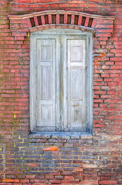 Fototapeta Detail of a brick wall with closed window