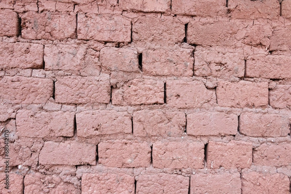 Fototapeta Old adobe mud brick wall in frontal view