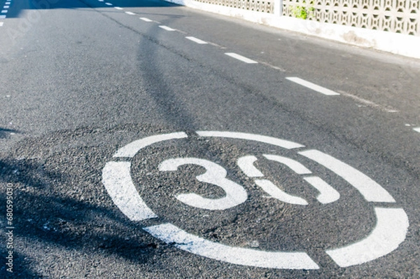Obraz 30kph/30mph speed limit painted on a road