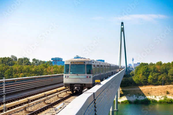 Obraz Vienna metro train passing a bridge over Danube river
