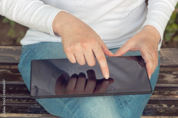 Fototapeta Woman using digital tablet computer