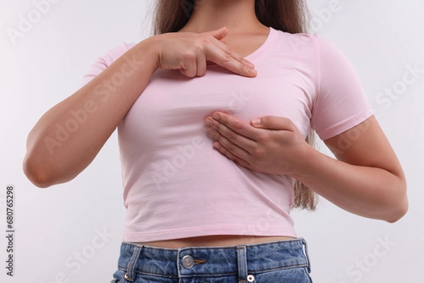 Obraz Woman doing breast self-examination on white background, closeup