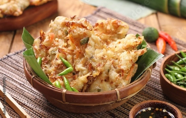 Fototapeta Bakwan sayur is Indonesian deep fried vegetable fritters. Found nation wide, mostly sold by street food vendors, the most popular version uses a mix of cabbage, carrot, and mung bean sprouts.