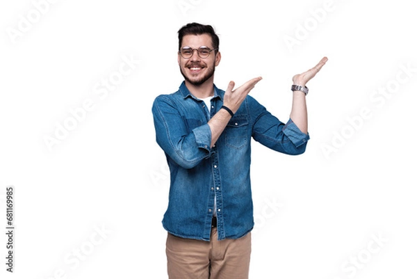 Fototapeta smiling young casual man presenting something on transparent background