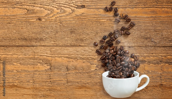 Fototapeta White cup with coffee beans on rustic wooden background flat lay. Copy space