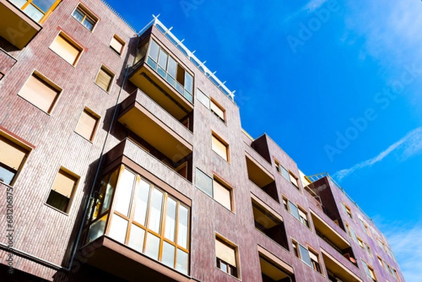 Fototapeta Modern residential building with tiled facade in a sunny day, Italy