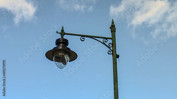 Obraz "Lamp post against a blue sky background."