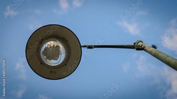 Obraz "Lamp post against a blue sky background."