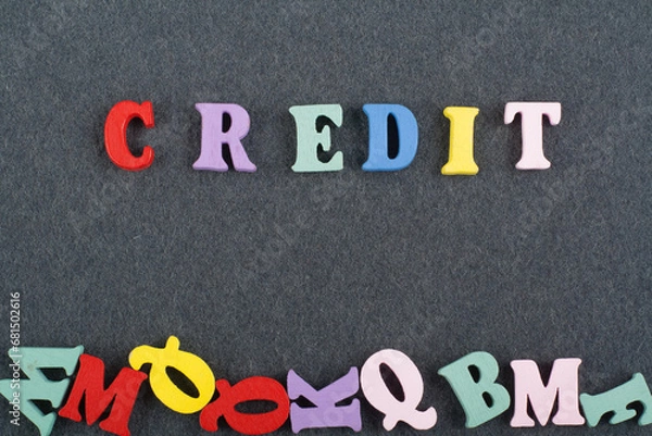 Fototapeta CREDIT word on black board background composed from colorful abc alphabet block wooden letters, copy space for ad text. Learning english concept.