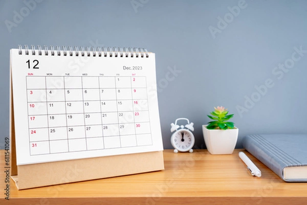 Fototapeta December 2023, Monthly desk calendar for 2023 year on wooden table.