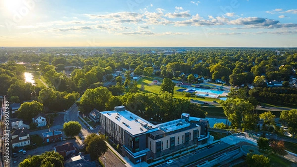 Fototapeta Apartment building aerial Muncie, IN with Tuhey Pool on other side of White River in late afternoon