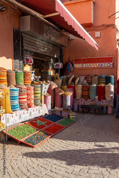 Obraz Typical shop in the city of Marrakech, with bags of spices outside the shop and a nice cartes.