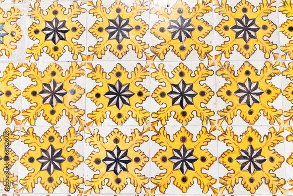 Fototapeta Yellow decorative tiles on a house near the Tunis Souk.