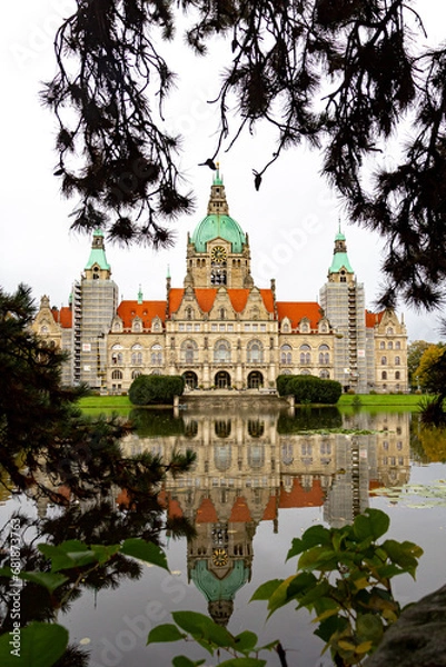 Obraz New Town Hall of Hannover city with reflecting and trees around. Lower Saxony, Germany. Vertical view