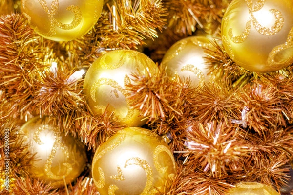 Fototapeta Christmas decorations background. Golden Christmas tree balls and tinsel strips